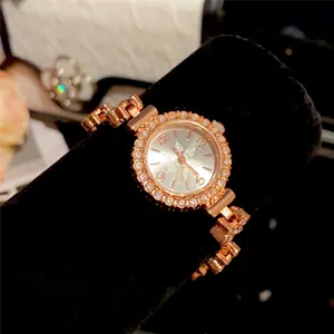 Exquisite rose gold watch featuring a rhinestone flower bezel and elegant chain bracelet