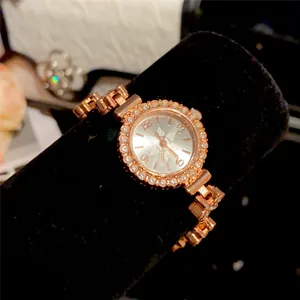 Detailed macro view of a rose gold floral bracelet watch with a rhinestone bezel display.