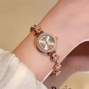 Close-up of a elegant rose gold floral bracelet watch with sparkling rhinestone accents