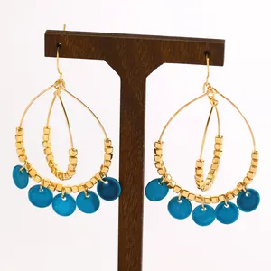 Detailed view of retro ethnic double-layer hoop earrings with blue shell discs