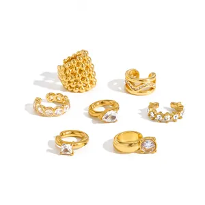 Detailed macro view of seven gold-plated zircon ear cuffs with various stone shapes