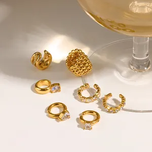 Detailed macro view of assorted gold ear cuffs with sparkling rhinestone and zirconia accents