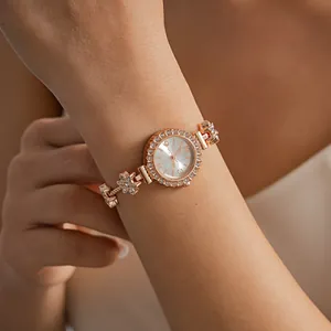Elegant rose gold rhinestone flower bracelet watch on a female wrist