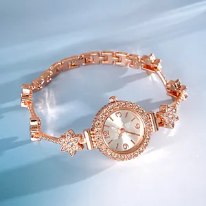 Detailed view of a rose gold flower bracelet watch with sparkling crystal accents.