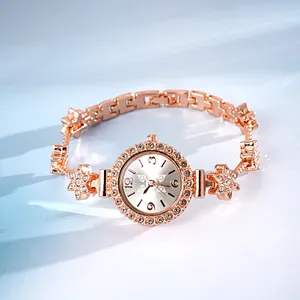 Close-up of rose gold bracelet watch with rhinestone flower charms and elegant dial