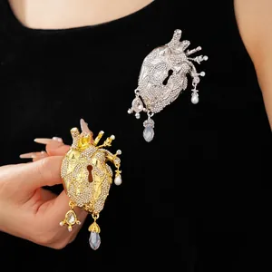 Exaggerated anatomical heart brooch with keyhole design, rhinestones and pearl dangles