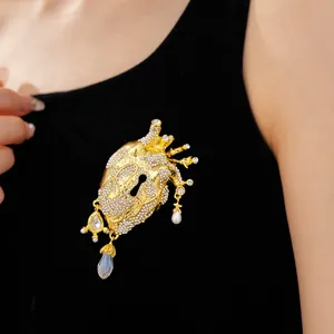 Anatomical heart brooch with sparkling rhinestones and elegant hanging pearls