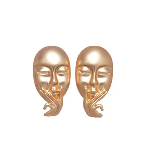 Artistic matte gold face mask stud earrings with silence gesture design for women