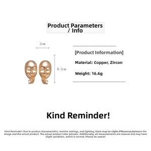 Detailed view of matte gold human face mask profile stud earrings with silver needles