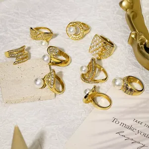 Detailed close-up of vintage gold plated rings with elegant pearls and sparkling rhinestones.