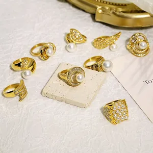 Detail view of vintage 18k gold-plated stainless steel rings with pearls and crystals
