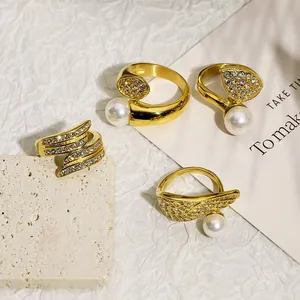 Close-up of vintage 18k gold plated stainless steel rings with pearls and diamonds