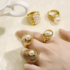 Detailed macro view of vintage 18k gold plated rings with pearls and sparkling rhinestones