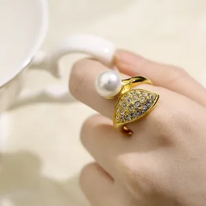 Close-up of elegant 18k gold plated stainless steel ring with pearl and crystals