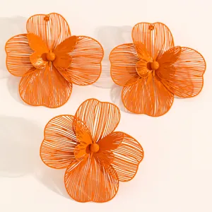 Detailed view of vibrant orange hollowed-out flower jewelry set with butterfly detail