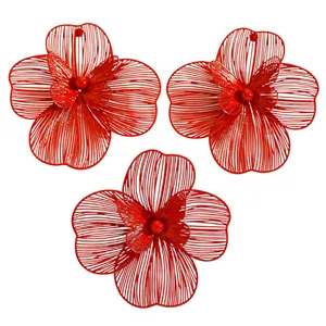 Detailed view of red filigree flower jewelry with double-layered hollow petal design