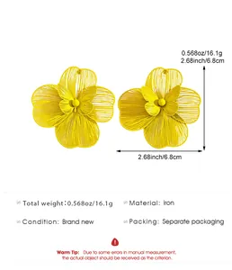 Macro view of yellow openwork flower earrings with butterfly detail and size specs.