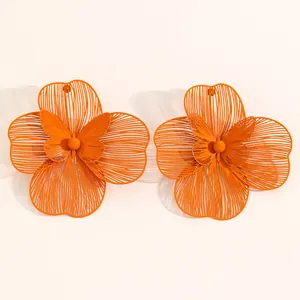Oversized orange hollow floral earrings with a delicate butterfly center detail