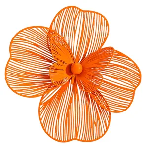 Detailed view of a large orange hollowed-out flower with a butterfly center ornament