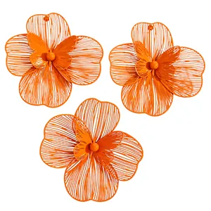Vibrant orange hollowed flower jewelry detail showing layered butterfly design