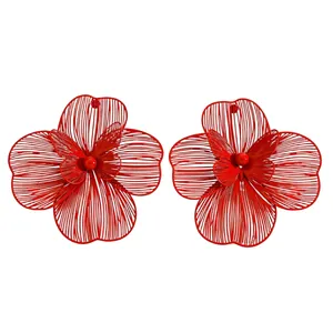 Detailed view of oversized red hollow flower earrings with butterfly center design