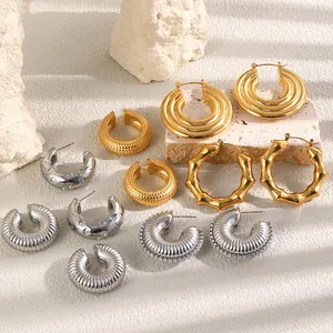 Detailansicht verschiedener klobiger goldener und silberner Edelstahl-Ohrringe