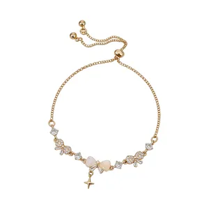 Elegant French gold slider bracelet featuring zircon bow charms and a cat-eye stone bow