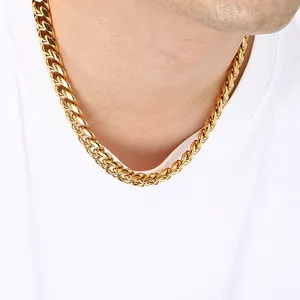Close-up of a chunky gold stainless steel Cuban link chain necklace on a male neck.