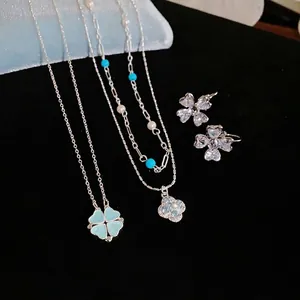 Elegant silver-tone four-leaf clover necklace and earrings set with zircon and pearls