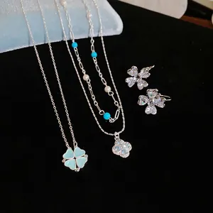 Detailed close-up of luxury zircon flower pendant necklaces and matching earrings set