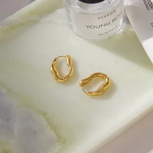 Detailed view of luxury gold-plated stainless steel irregular wavy hoop earrings set