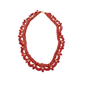 Handmade elegant red beaded necklace with golden flower charms on a clean white background