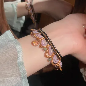 Detailed view of a multi-layer handmade beaded bracelet with faceted crystal teardrop pendant