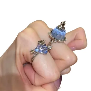 Elegant silver ring featuring a blue resin pudding charm and grape-shaped zircon clusters.