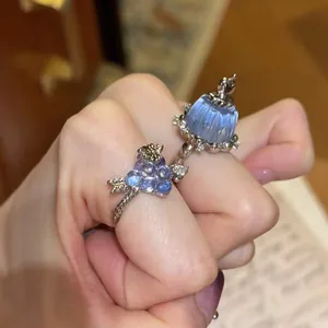 Detailed macro view of an exquisite blue resin pudding and zircon grape cluster silver ring.