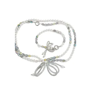 Ensemble élégant de lanières de téléphone en perles et cristaux avec nœuds strass.