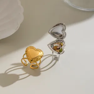 Detailed macro view of the openable heart locket ring revealing its hidden interior photo compartment