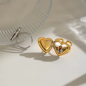 Detail of a gold heart locket ring showing an open compartment for a miniature photo