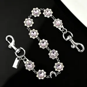 Close-up of luxury flower chain with purple crystals and silver metal clasps