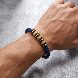 Detail view of a men's blue braided leather bracelet with gold knurled stainless steel beads