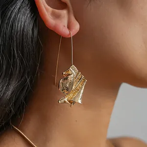 Detailed view of abstract hammered gold folding book style dangling earring for women