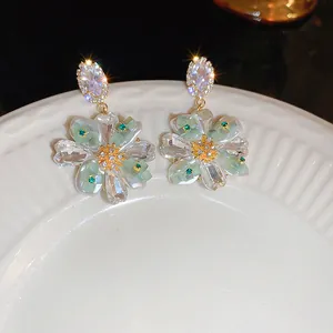 Gros plan de boucles d'oreilles vintage en fleur avec zircons marquise et pierres