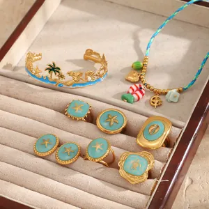 Collection of gold-plated ocean theme jewelry with blue enamel and starfish details