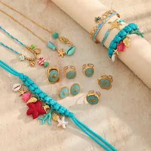 Detail view of ocean-themed jewelry set with blue braided cord and gold starfish charms.