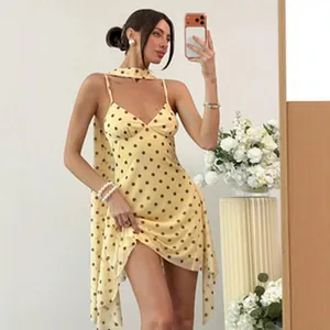 Yellow polka dot spaghetti strap mini dress with a bodycon fit for a sexy summer look.