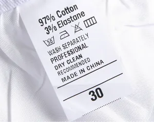 Close-up of wash care label showing 97% cotton material for men's denim jeans