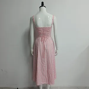Back view of a pink gingham midi dress featuring a lace-up corset and straps.