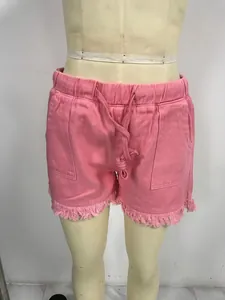 Pink high waist elastic waistband denim shorts featuring a frayed tassel hem detail