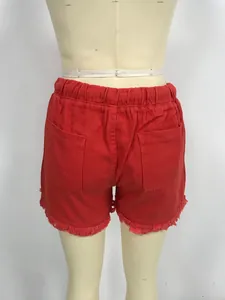 Rear view detail of high-waisted red denim shorts with elastic waist and frayed hem.