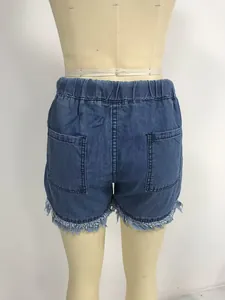 Back view of blue high-waisted denim shorts with elastic waist and stylish frayed hem.